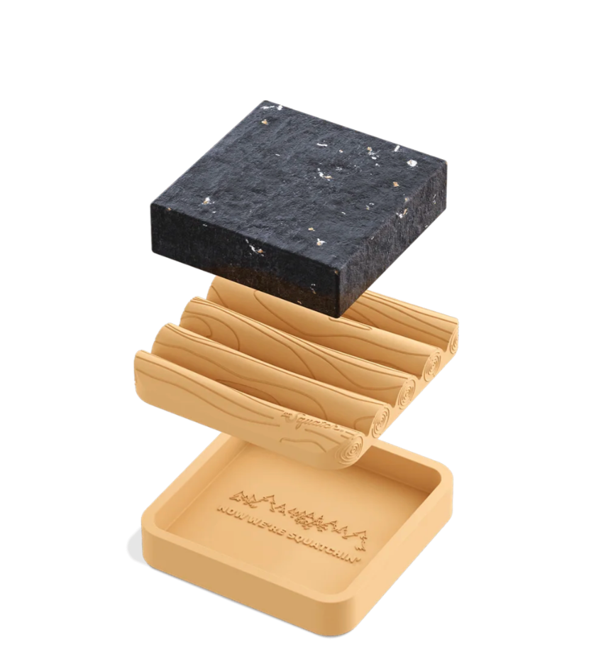 Set of stone coasters with wooden holder on a white background