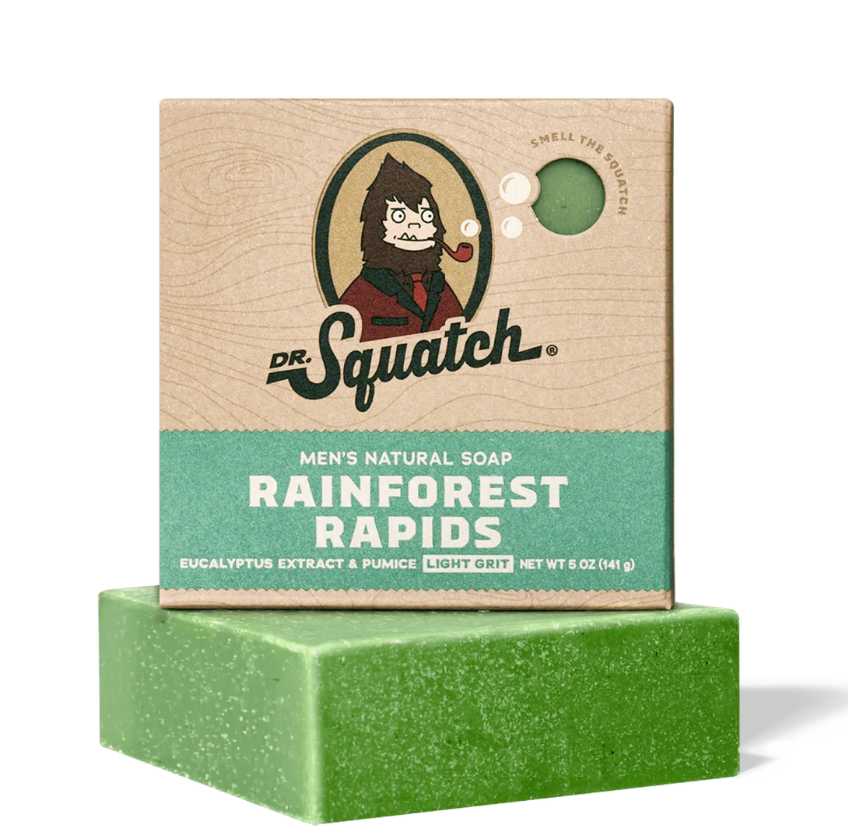 Green bar of soap with Dr. Squatch packaging on a white background