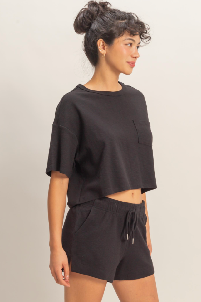 Woman wearing a black outfit with a plain background