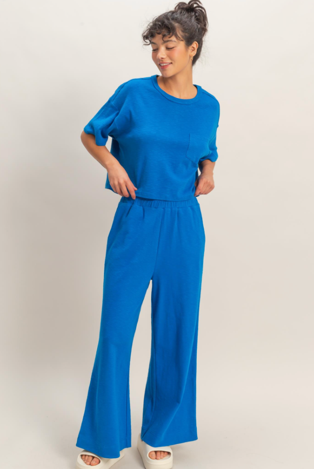 Woman wearing a blue outfit against a plain background