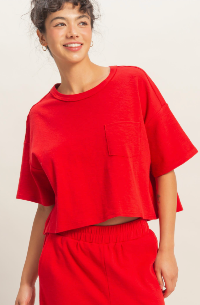 Person wearing a red outfit with a plain background