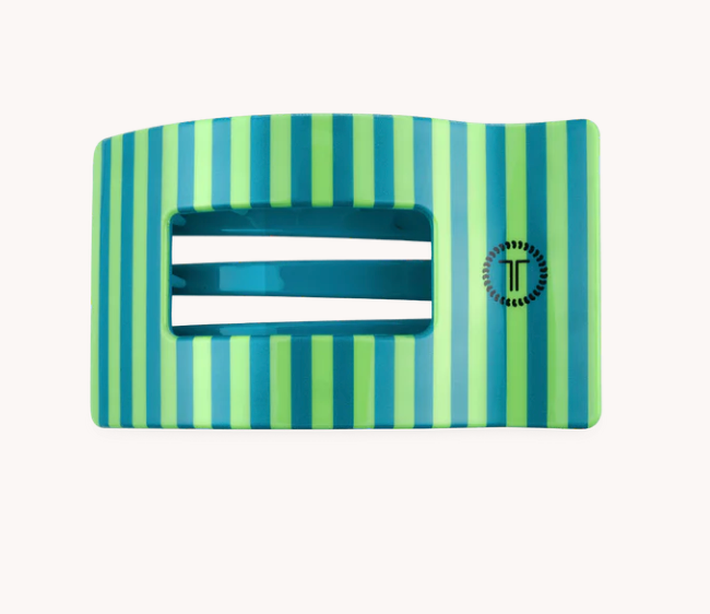 A rectangular belt buckle with vertical stripes in shades of green and blue, featuring a central cutout with horizontal white bars and a circular logo on the right side.