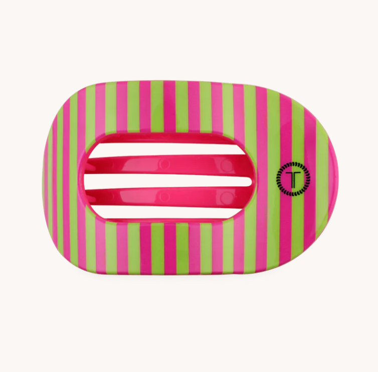 A pink and lime green striped hair claw clip with a glossy finish and a small black circular logo on the side, set against a plain off-white background.