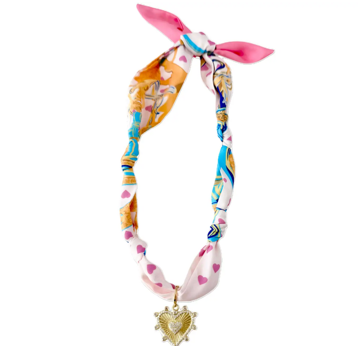 A colorful silk scarf necklace with a pink bow at the top and a gold heart pendant at the bottom, displayed on a clean white background.