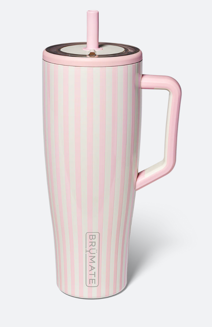 A tall pink and white vertically striped insulated travel tumbler with a handle, lid, and straw, shown on a light gray background. The brand name BRUMATE is printed vertically near the bottom.