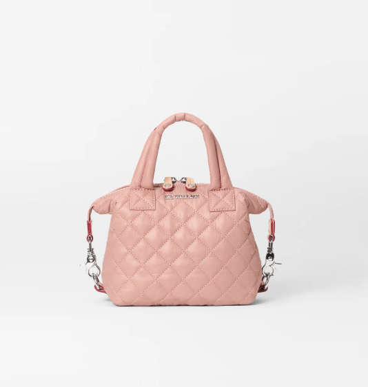 A light pink quilted leather handbag with top handles and a detachable shoulder strap, shown against a plain white background.