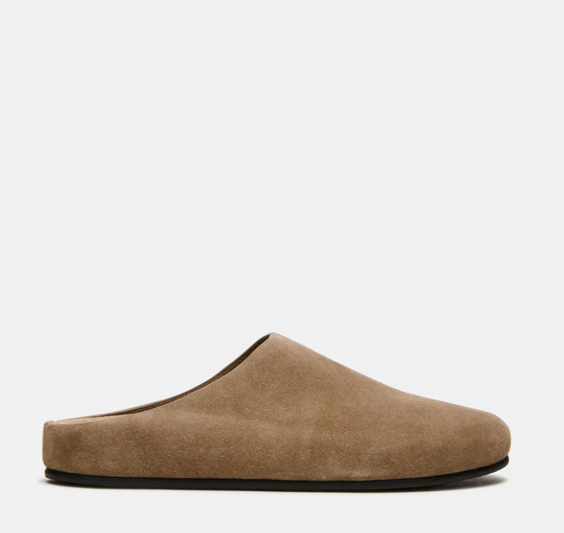 A single taupe-brown suede mule slipper shown in a side profile against a clean, light gray background.