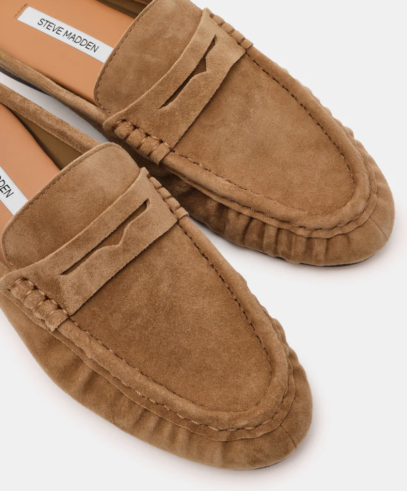 A pair of Steve Madden suede penny loafers in a warm tan-brown color, shown from a close-up angle on a light gray background.