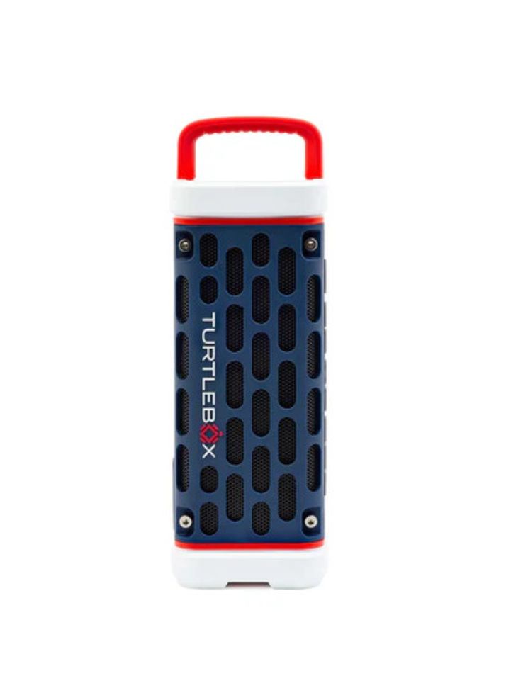 A portable Bluetooth speaker by TurtleBox, featuring a navy blue front grille, white top and bottom sections, and red accents on the handle and borders.