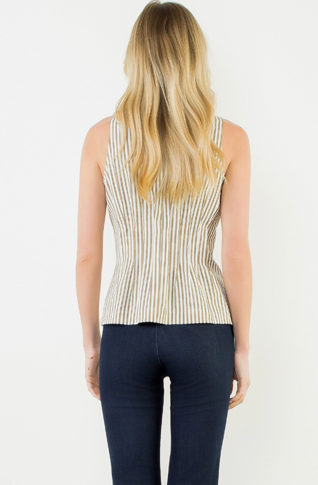 A woman viewed from the back wearing a sleeveless beige top with thin vertical dark stripes and dark blue jeans, against a plain white background.