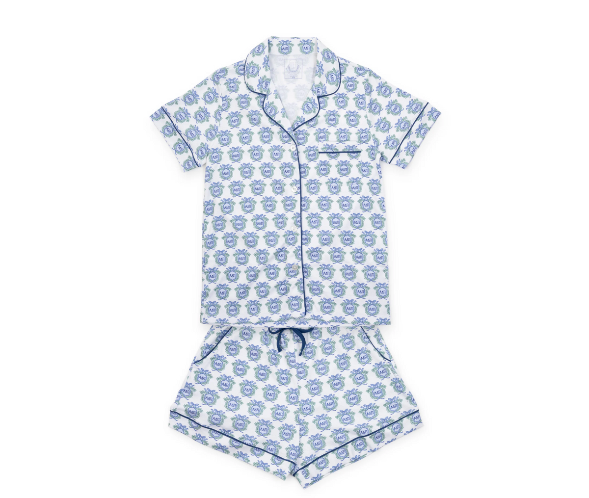 A two-piece short-sleeve pajama set laid flat on a white background, featuring a white base with a repeating blue cartoon face pattern and blue piping details.