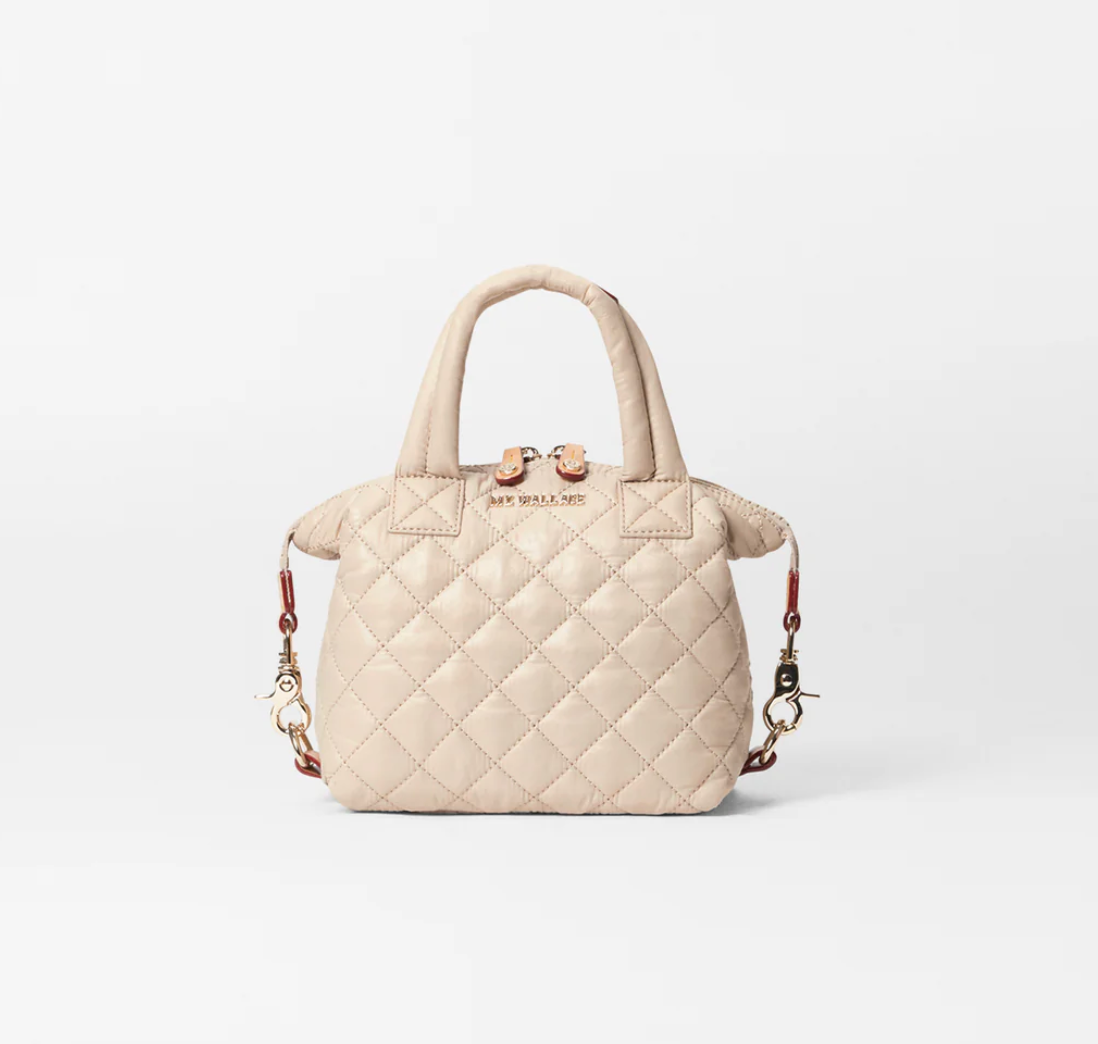 A light beige quilted leather handbag with top handles and a detachable shoulder strap, shown on a clean white background. The brand name 'JILL STUART' is visible on a small metal plaque on the front.