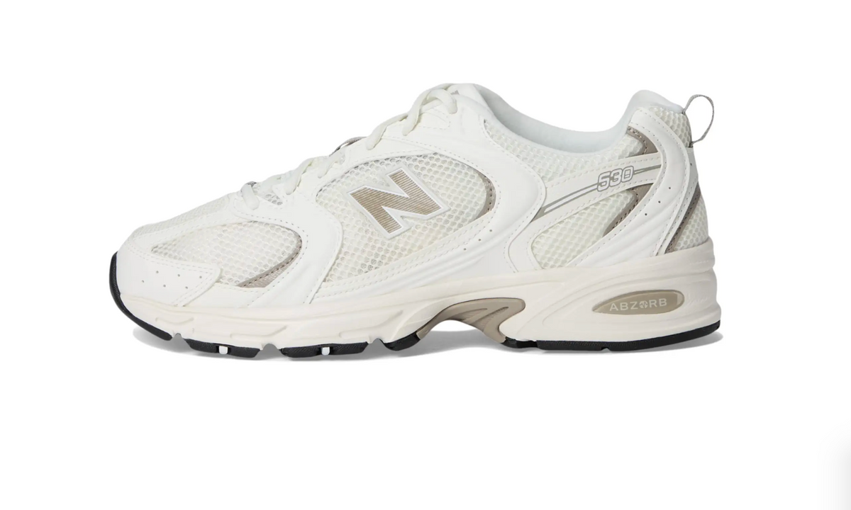 A New Balance 330 sneaker in off-white and beige, shown from a side profile view against a plain white background.