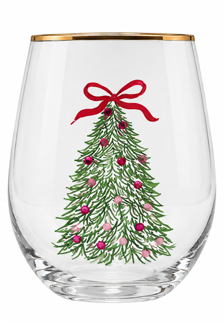 A clear stemless wine glass with a gold rim, decorated with a hand-painted green Christmas tree, red bow, and colorful ornaments, shown on a white background.