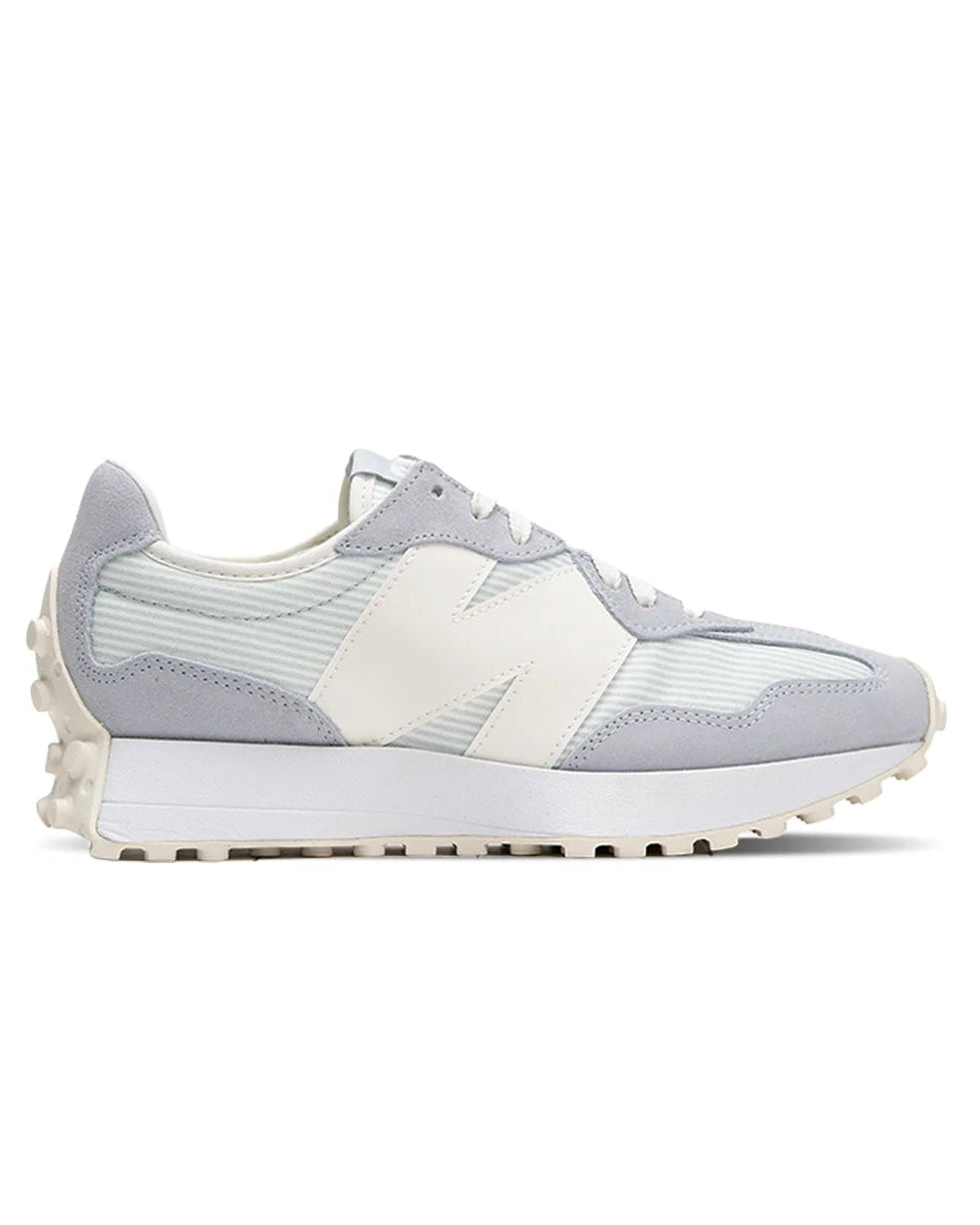 A light gray and off-white New Balance sneaker shown from the side profile against a solid white background.