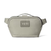 A light gray YETI shoulder bag with a top handle and adjustable strap, shown against a plain white background.