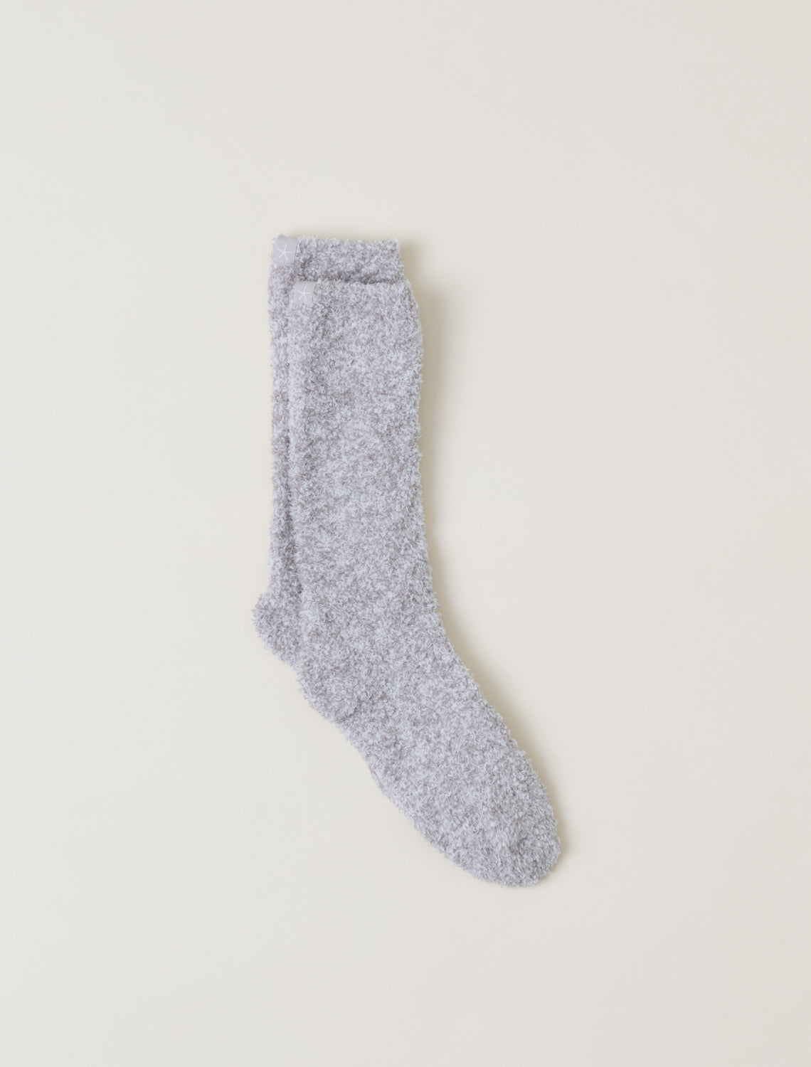 Gray fuzzy sock on a light beige background