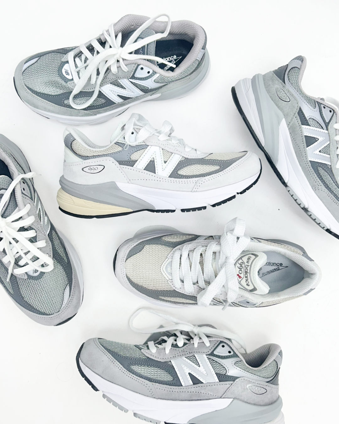 Six New Balance 990v4 running shoes in a gray, white, and silver colorway, arranged in a flat-lay pattern on a white background.