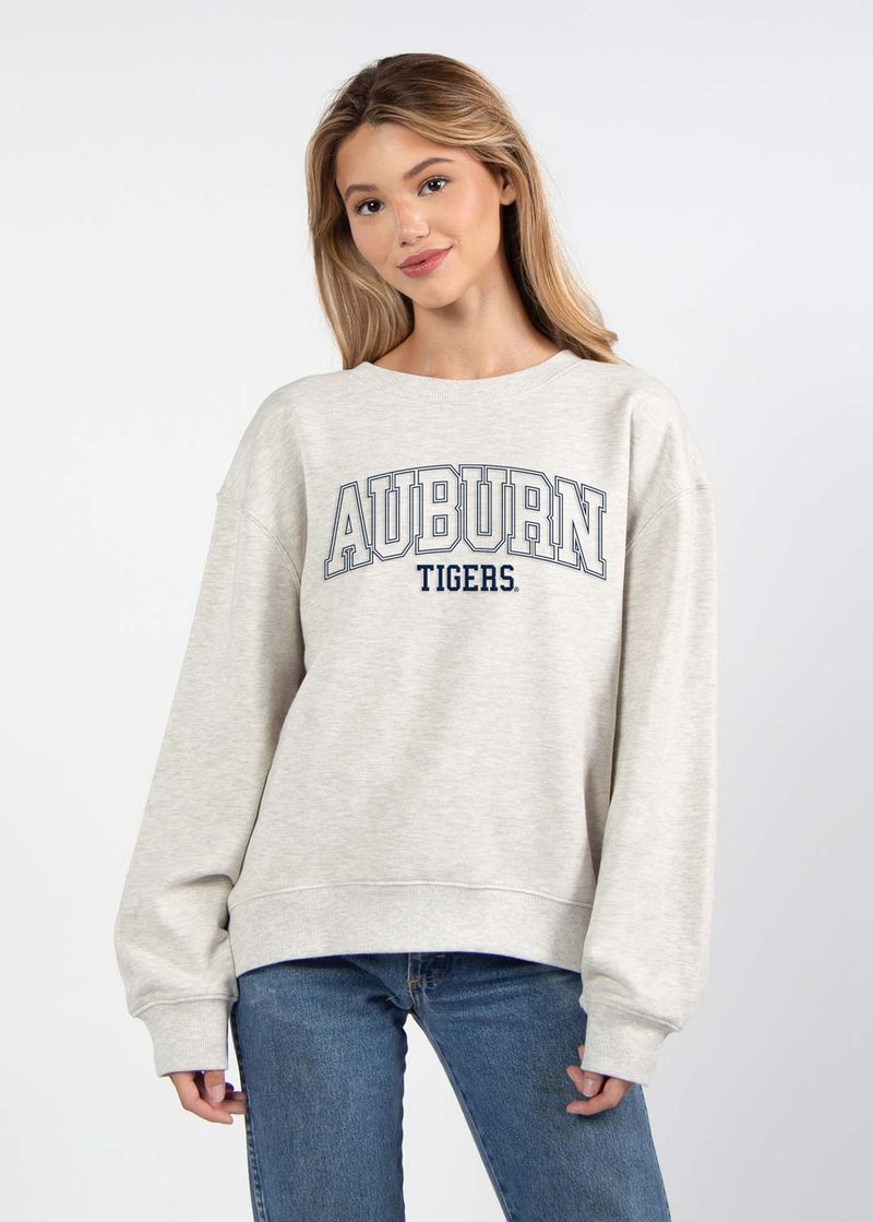 woman modeling a grey crewneck sweatshirt with "auburn tigers" written on it in navy letters