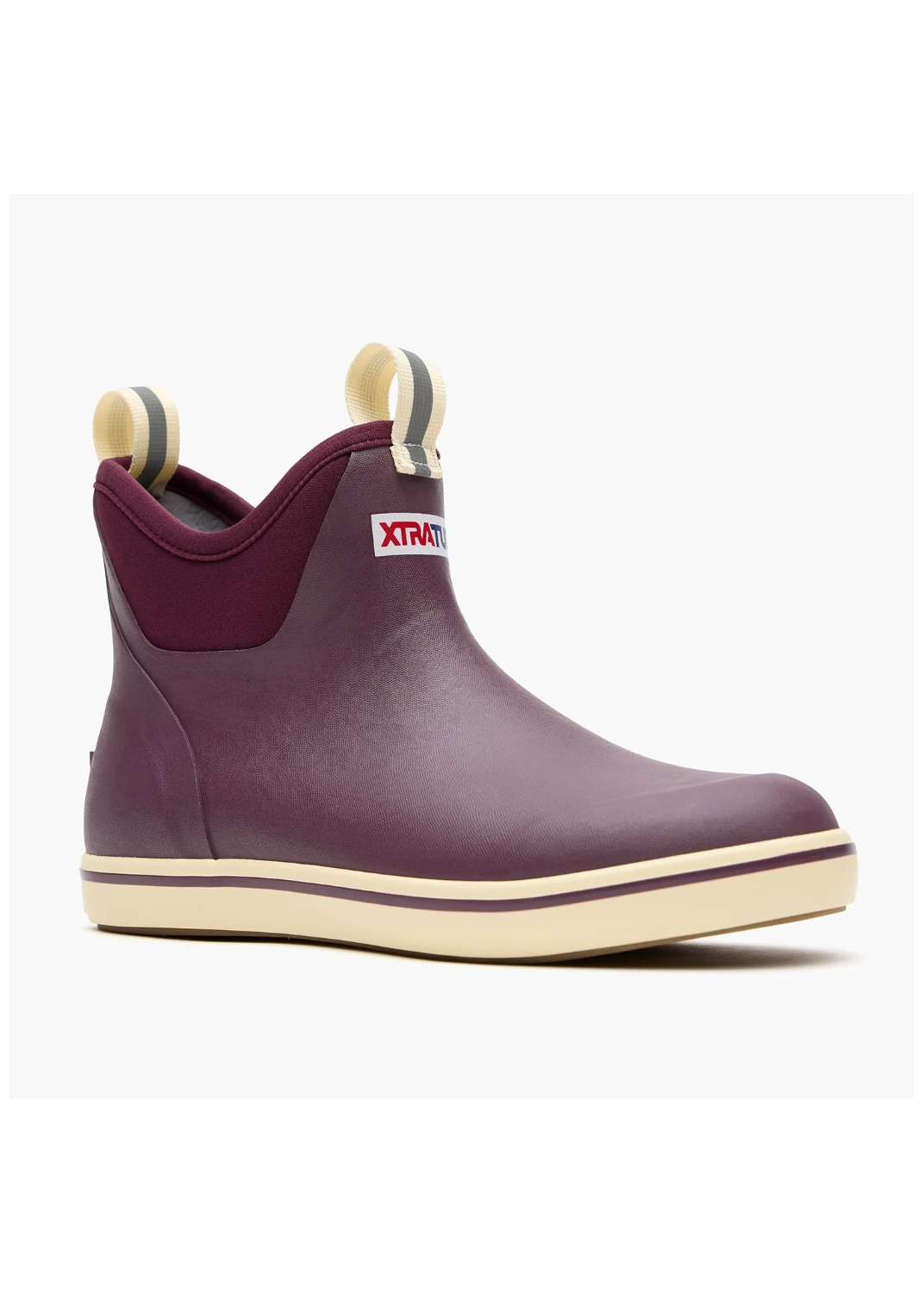 A single Xtravagante ankle rain boot in a deep plum purple color, featuring cream-colored rubber pulls and a matching cream outsole, shown against a plain white background.
