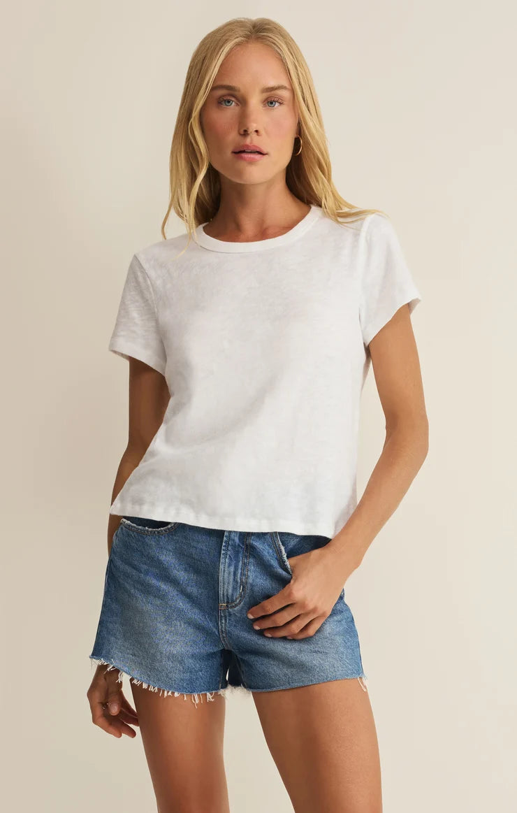 woman modeling a white tee with blue jean shorts