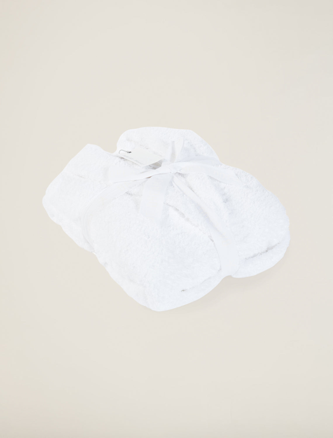 White blanket on a beige background