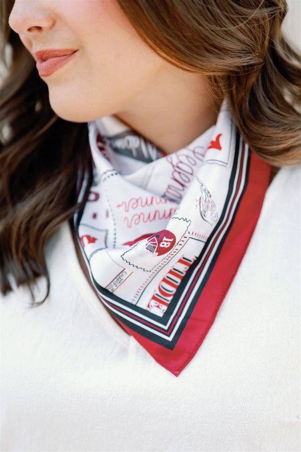 Woman wearing a patterned scarf with a white background