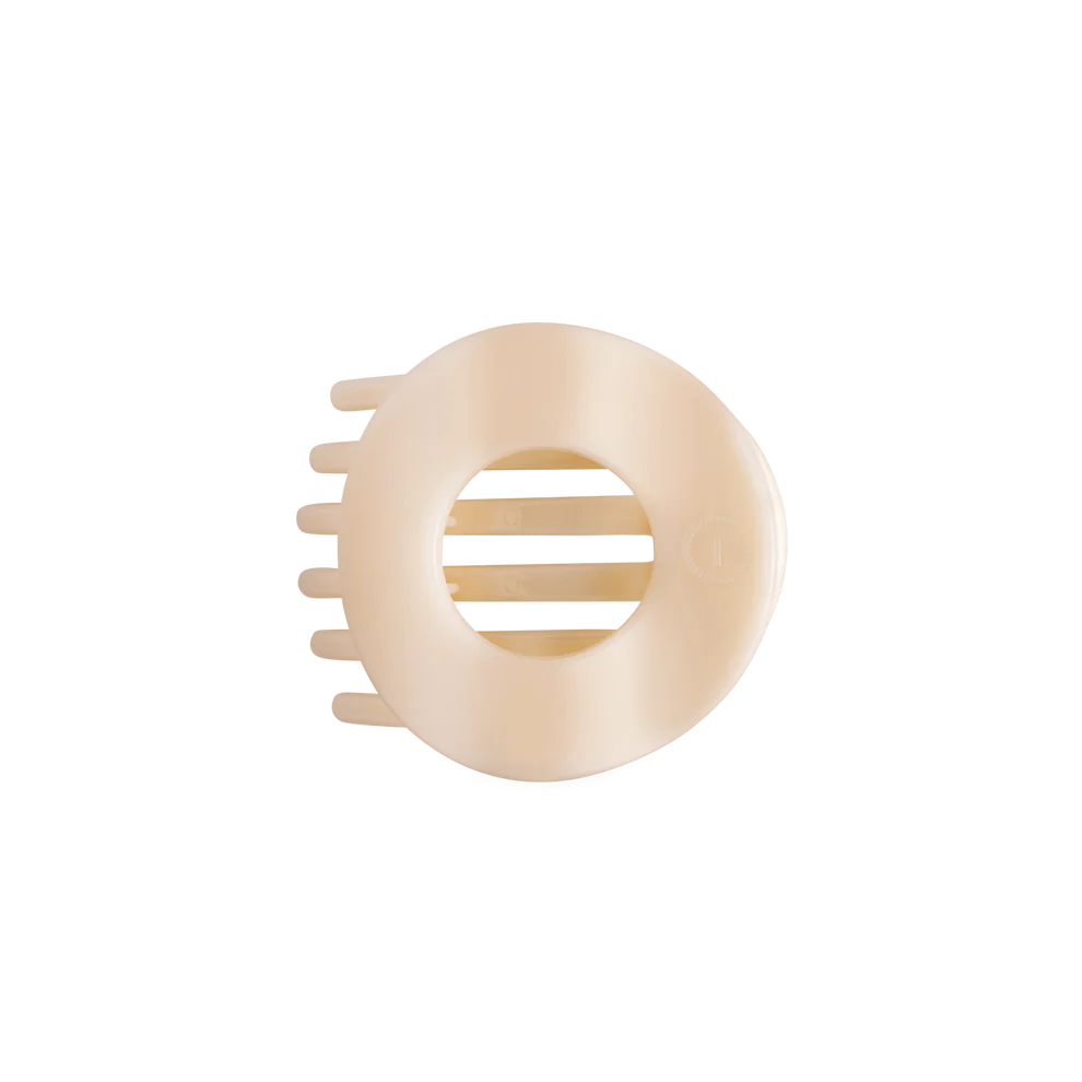 A single cream-colored plastic hair claw clip shown from a top-down view on a solid white background.