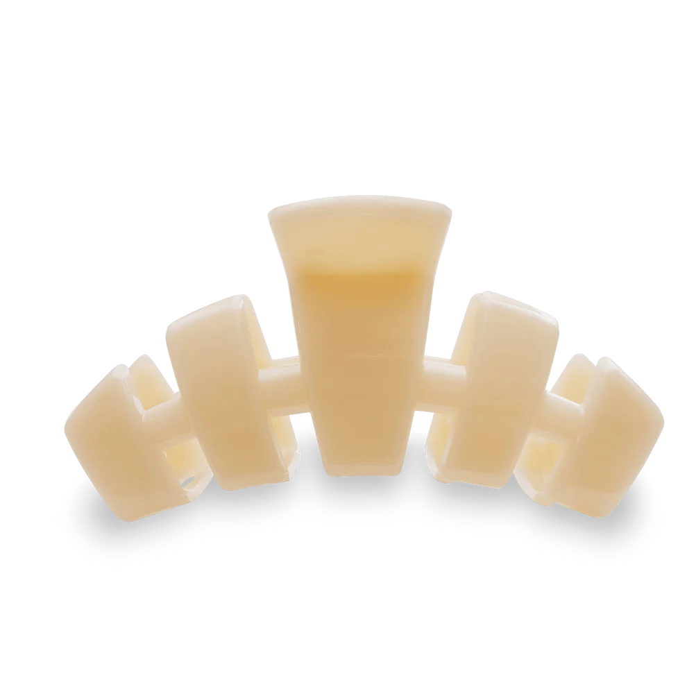A translucent cream-colored plastic hair claw clip on a solid white background.