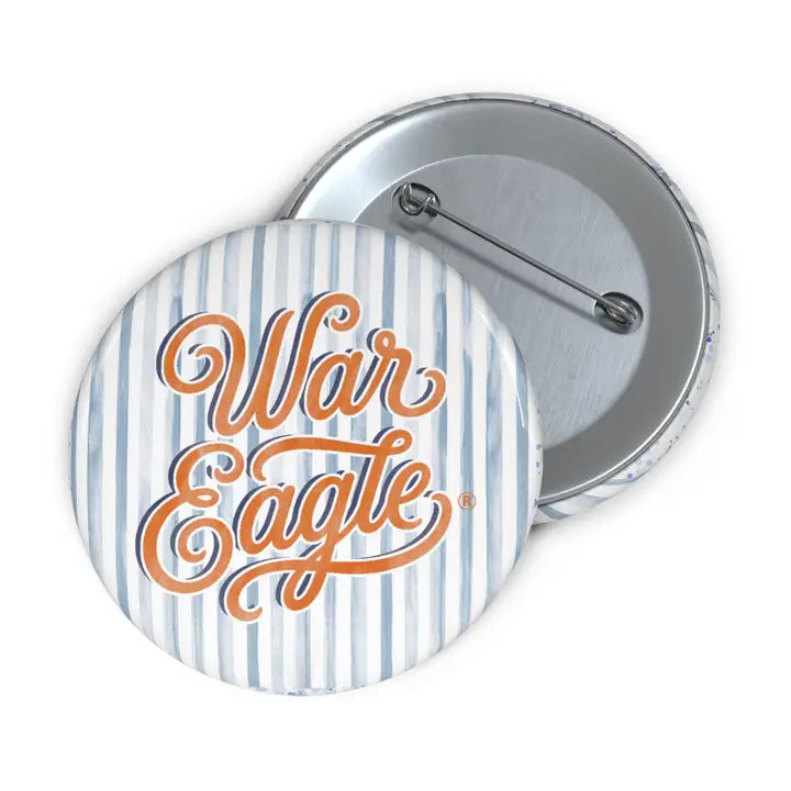 Two round pinback buttons showing the front and back. The front button has a white and light blue vertical stripe pattern with the words 'War Eagle' in orange cursive script.