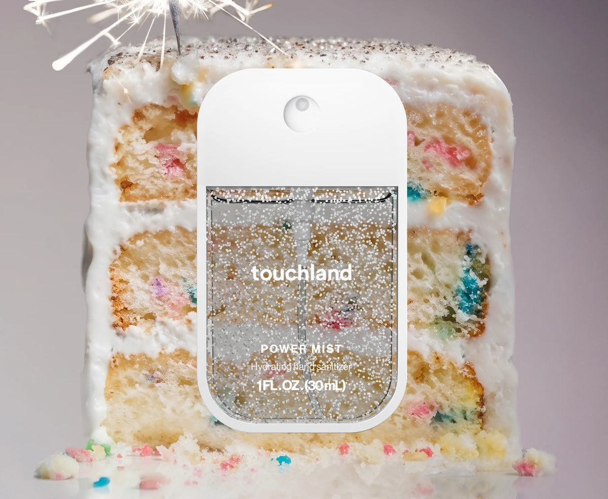 Touchland power mist bottle with a cake background