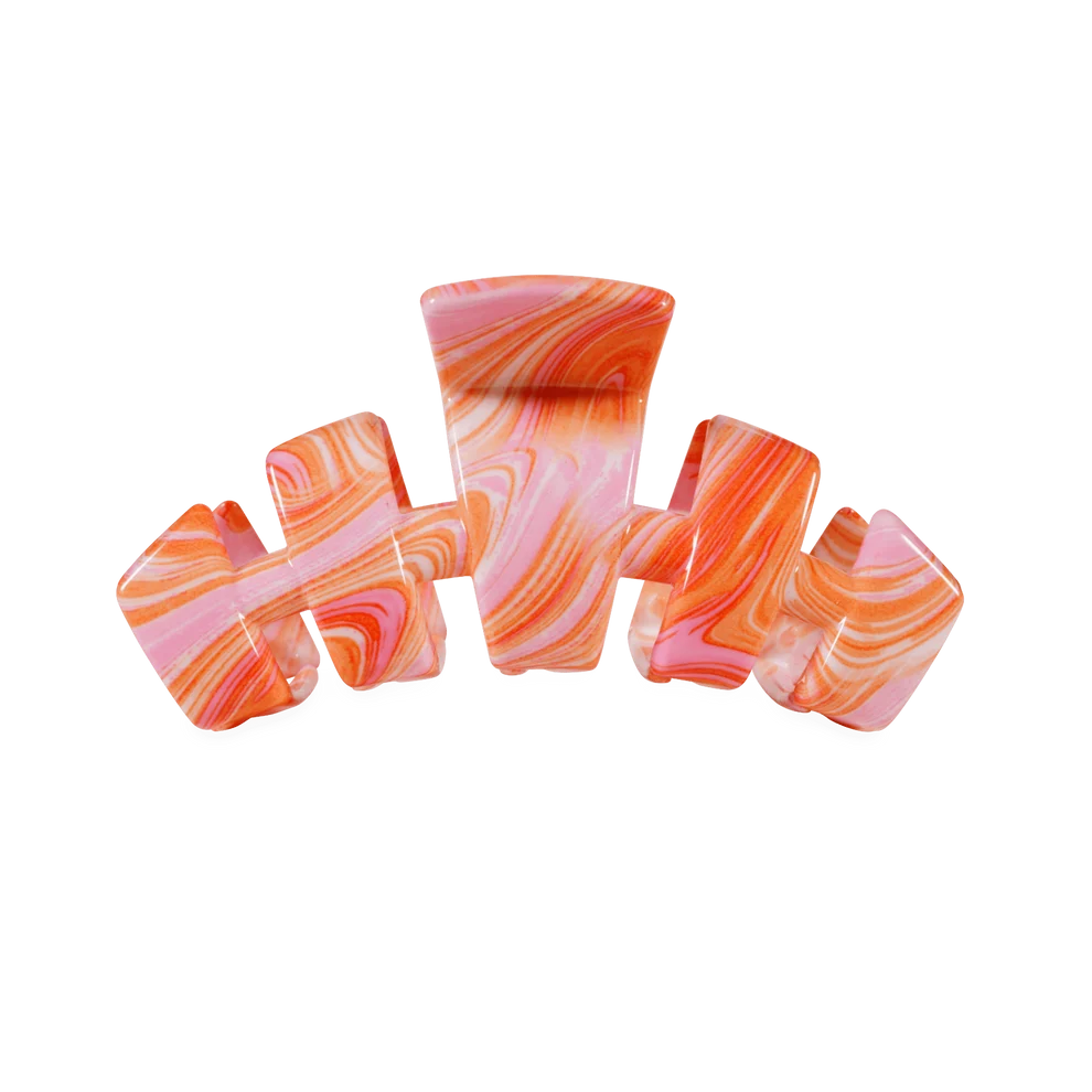 A glossy hair claw clip featuring a marbled swirl pattern of pink, orange, and white, isolated on a solid white background.