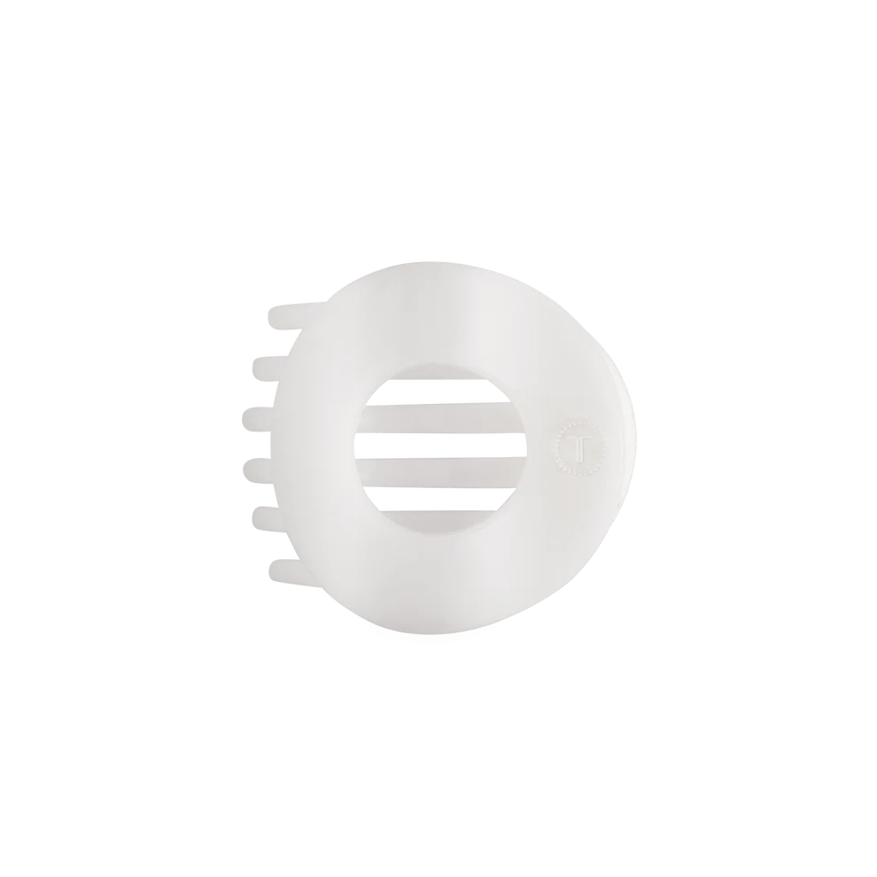 A white plastic hair clipper guard attachment with a circular design, shown on a plain white background.