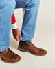 Front and side views of cowboy boots with cognac brown leather feet, navy shafts, decorative brown stitching, square toes, and low heels.