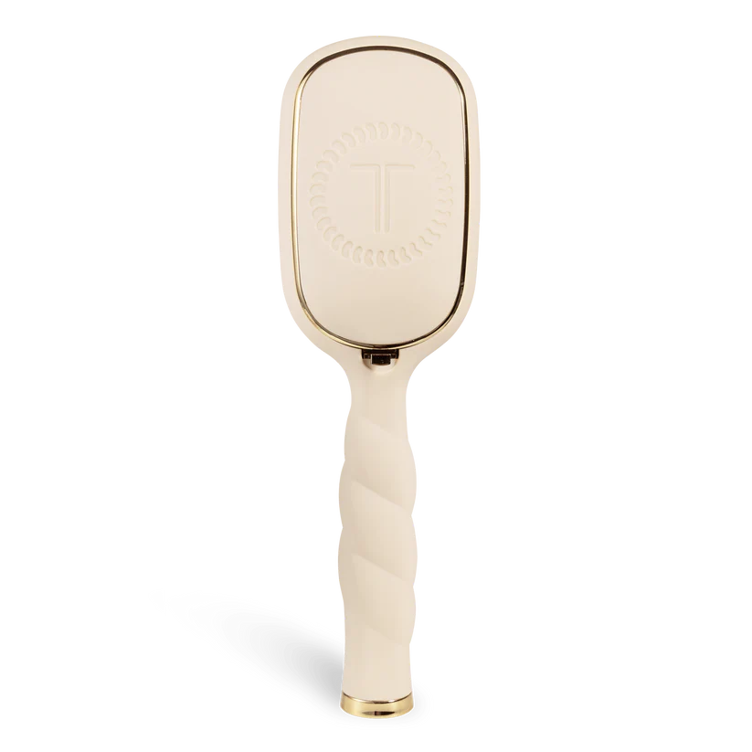 Gold paddle brush on a white background