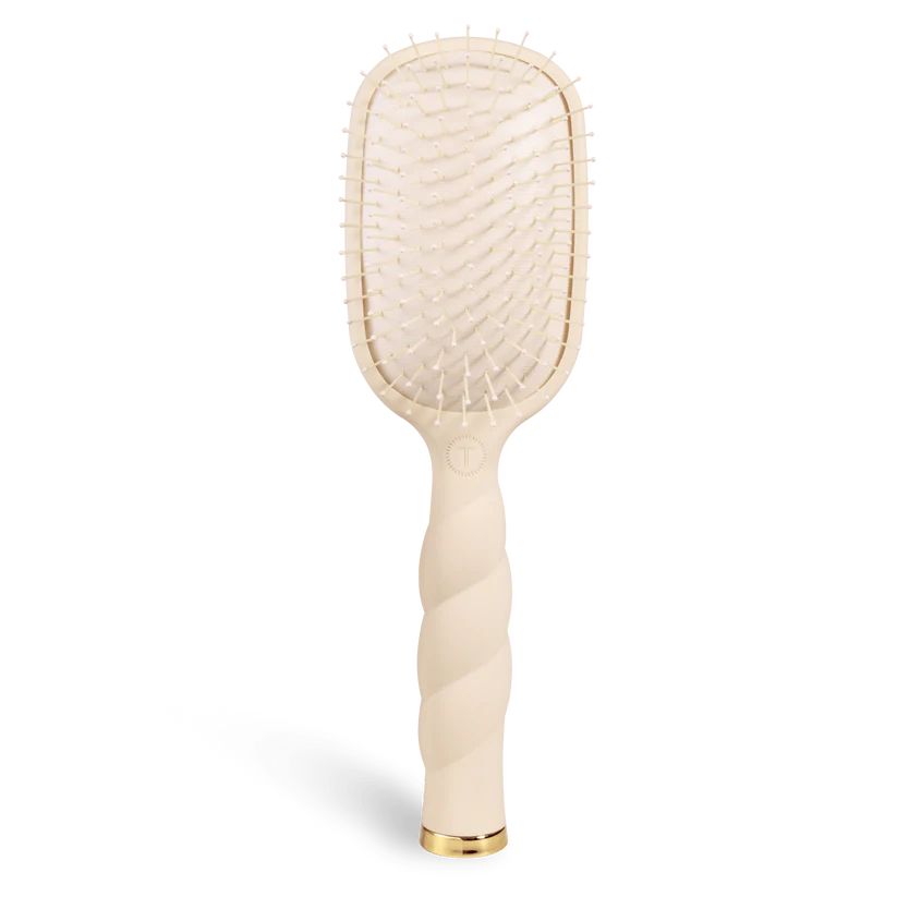 Beige paddle hairbrush on a white background