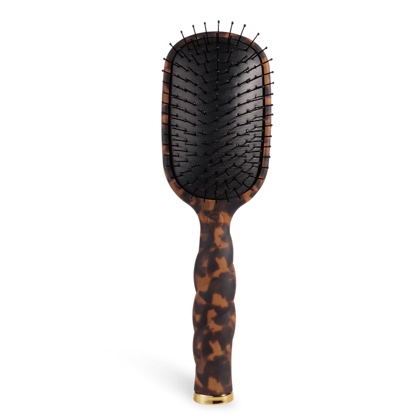 Hairbrush with tortoiseshell handle on a white background