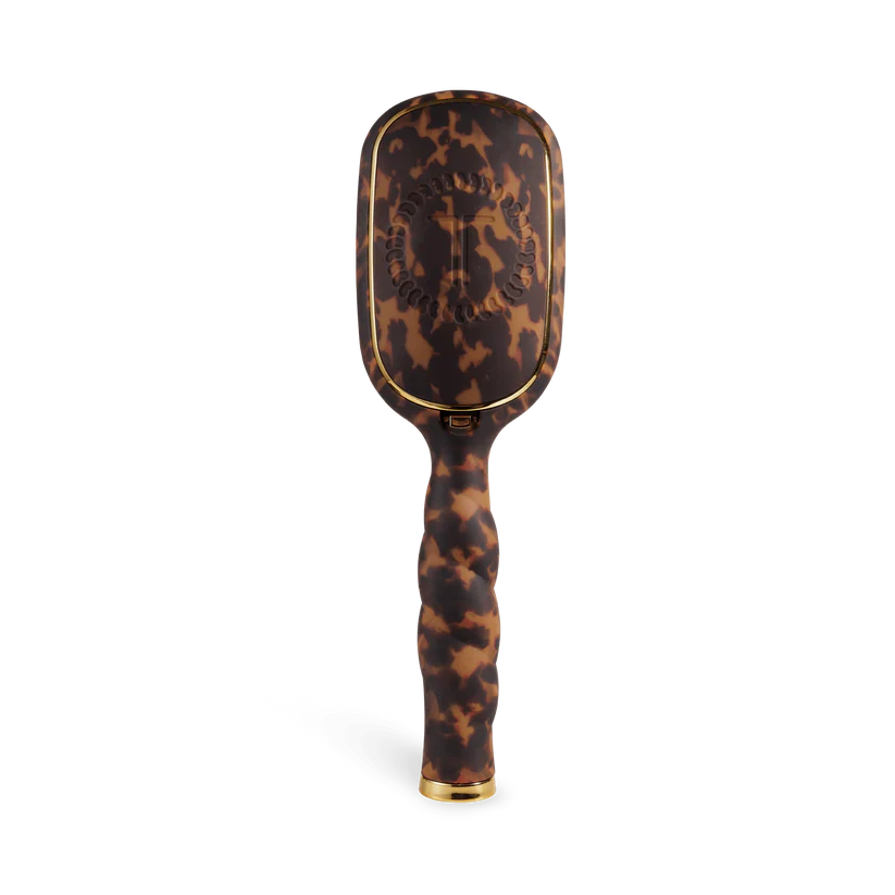 Tortoiseshell patterned hairbrush on a white background
