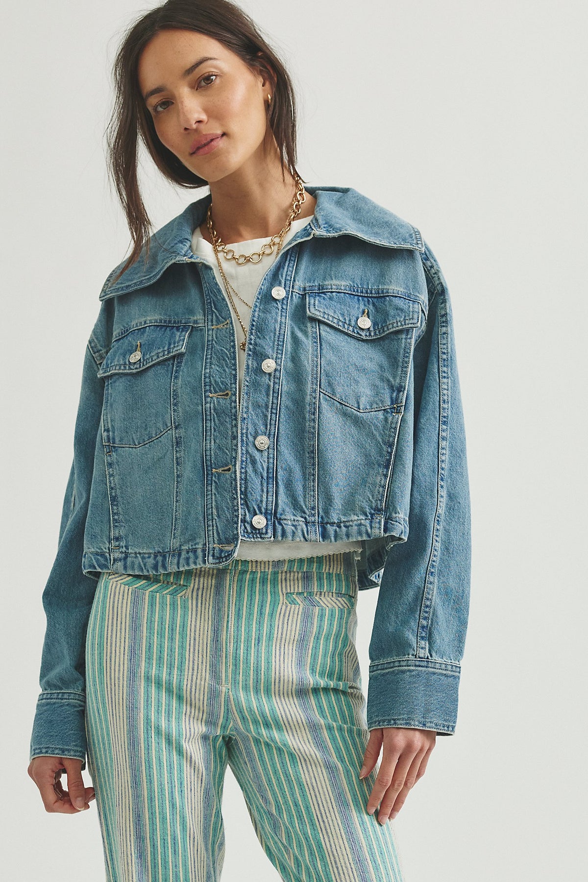 woman wearing a medium wash jean jacket