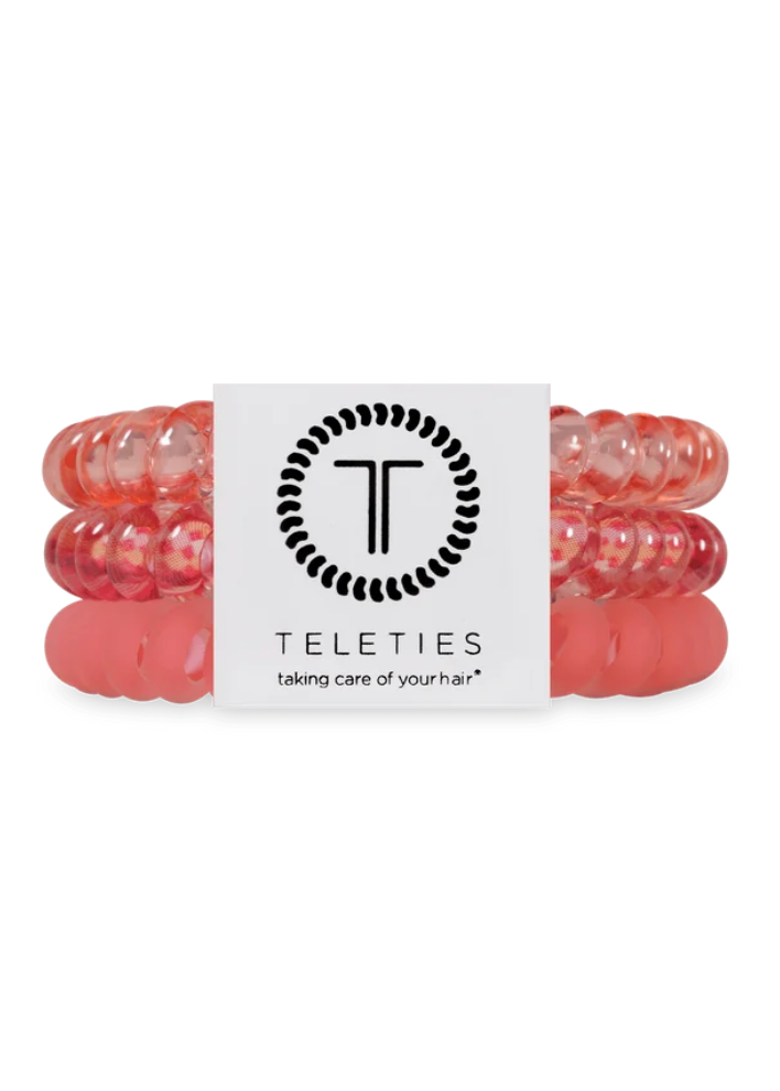Three translucent pink silicone hair extension bands stacked together with a white Teleties brand label in the center, on a plain white background.