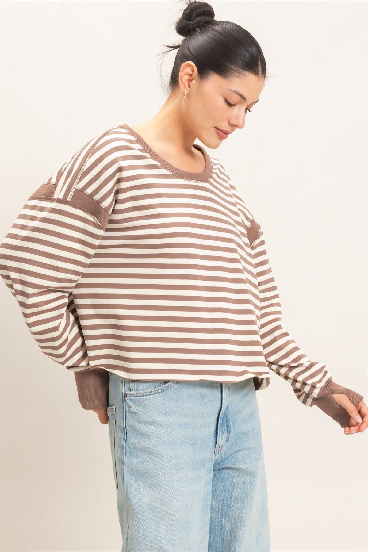 woman modeling a taupe and white striped long sleeve 
