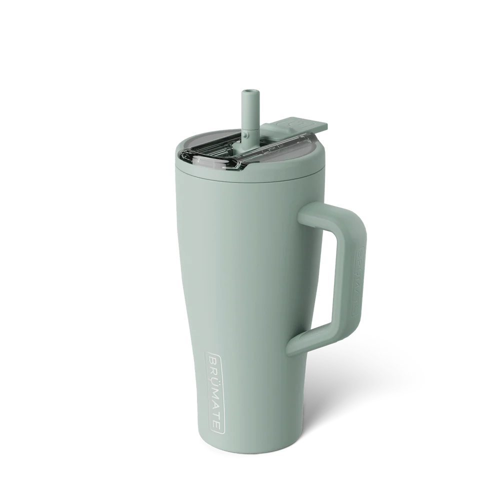 A sage green insulated travel tumbler with a handle, lid, and straw, shown on a clean white background. The brand name 'BRUNATE' is printed vertically on the lower front.