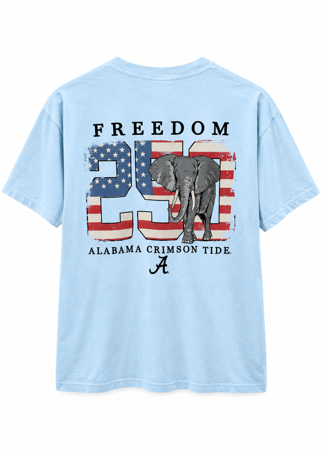 A light blue short-sleeve t-shirt shown from the back, featuring a large graphic print with the word 'FREEDOM', the number '25' filled with an American flag pattern, a gray elephant, and 'ALABAMA CRIMSON TIDE' text with an 'A' logo.