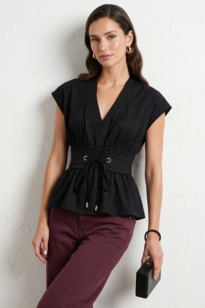 woman modeling v neck tie waist blouse with maroon jeans