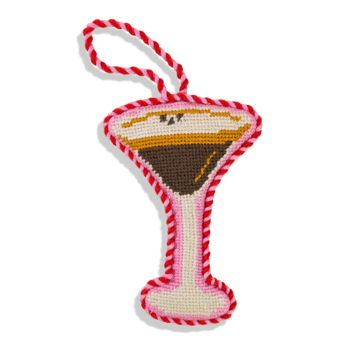 Crocheted martini glass toy with red and white striped handle on a white background