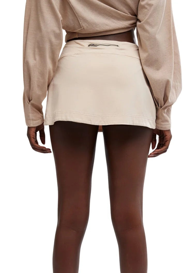 Woman modeling sand colored skirt and shirt