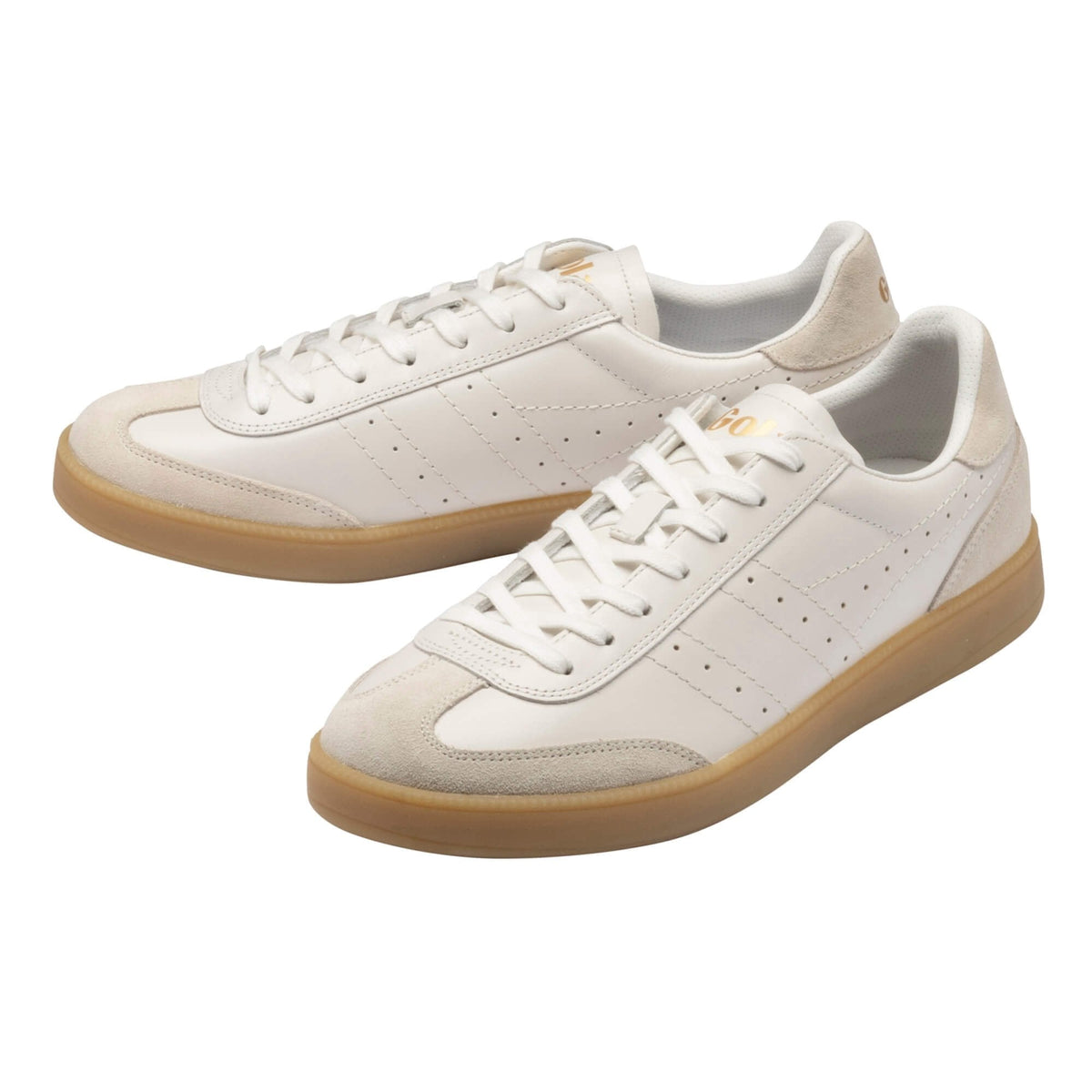 A pair of low-top sneakers in off-white leather and suede with white laces and translucent gum soles, photographed on a clean white background.