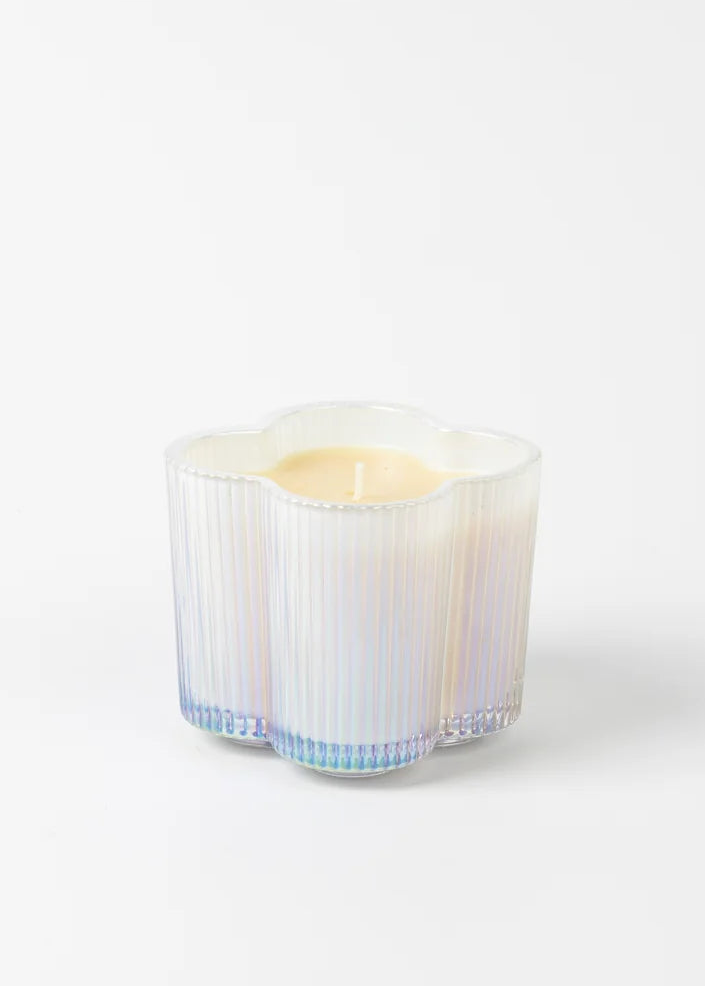 Candle in a decorative glass holder on a white background