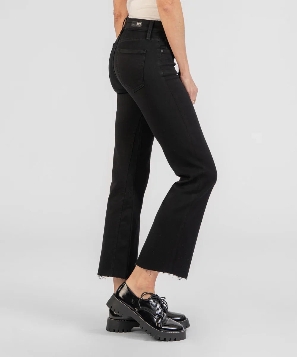 Person wearing black pants and black shoes on a white background