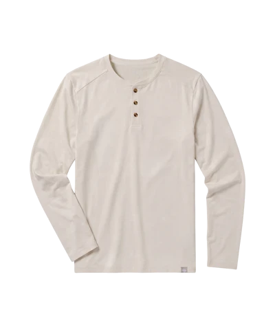 A long-sleeve henley shirt in a light cream or off-white color, featuring a three-button placket and a small woven label near the bottom hem, displayed on a solid white background.
